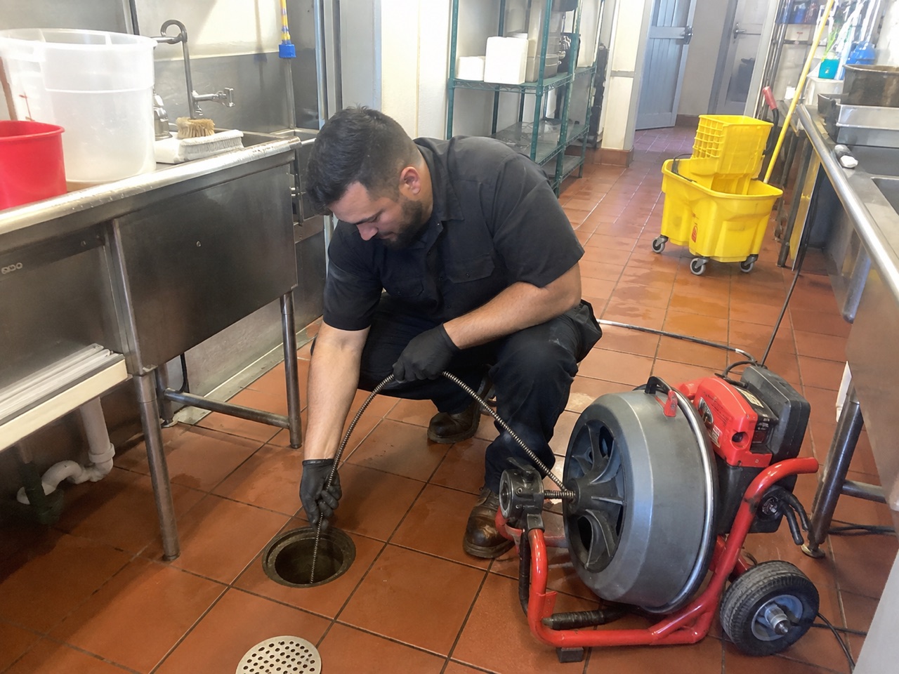 Commercial drain cleaning technician servicing a facility line in Stockton, CA