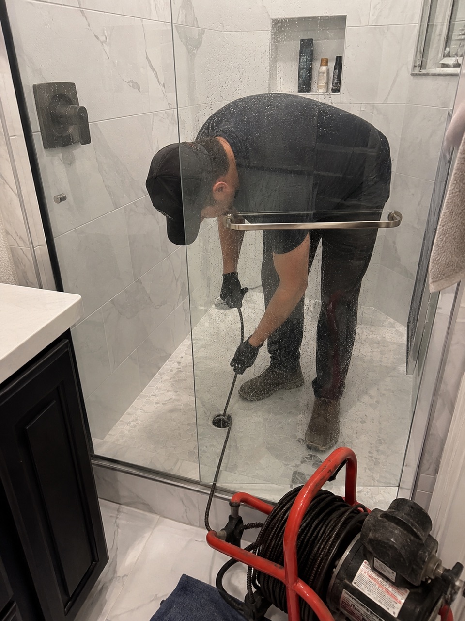 Clogged shower drain being cleared in a Stockton, CA bathroom
